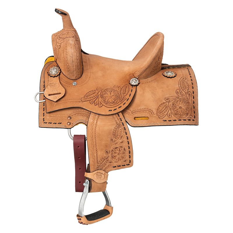 Tan leather western saddle with intricate floral carvings.