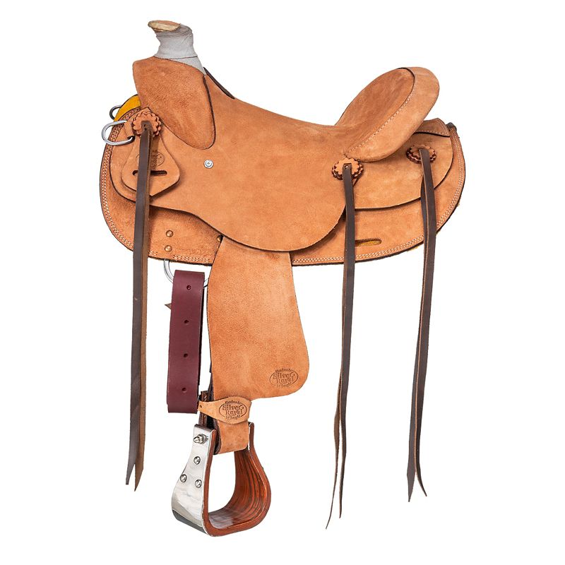 Tan leather western saddle with silver stirrups and straps.