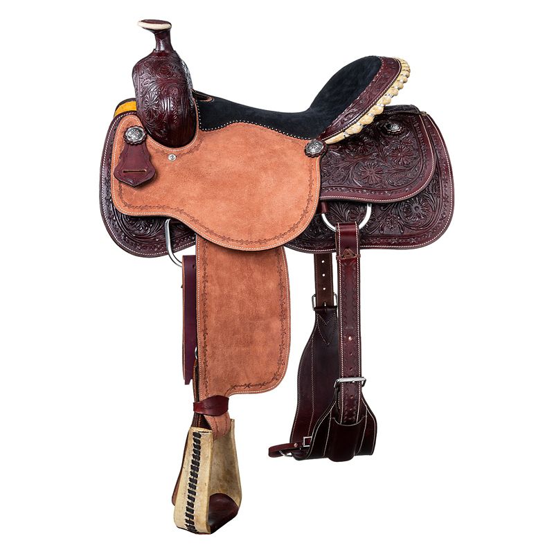 Intricately decorated brown western saddle with detailed leatherwork design.