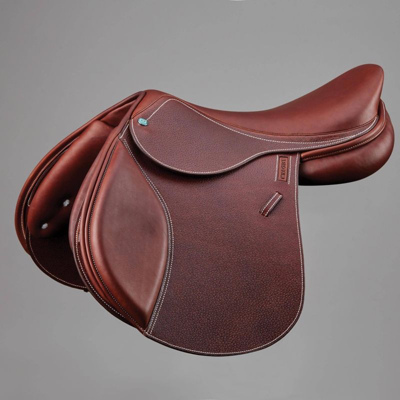 Luxurious brown CWD showjumping saddle with exquisite detailing displayed.