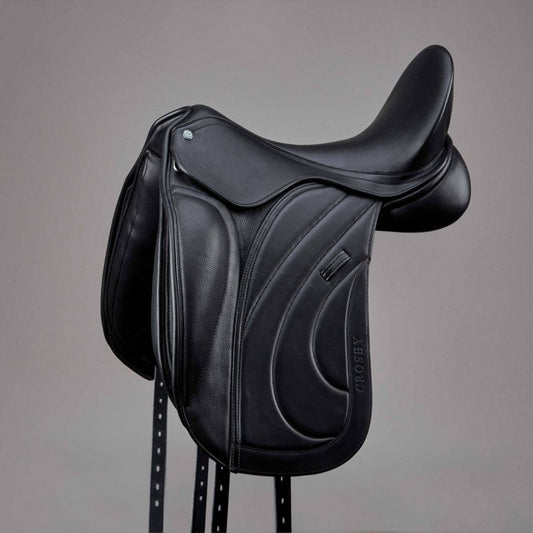 Black Crosby dressage saddle with elegant stitching on stand.