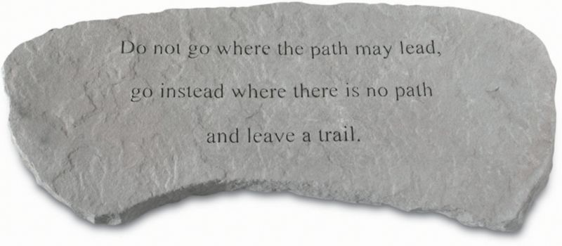 Stone plaque with inspirational quote engraved in black text.