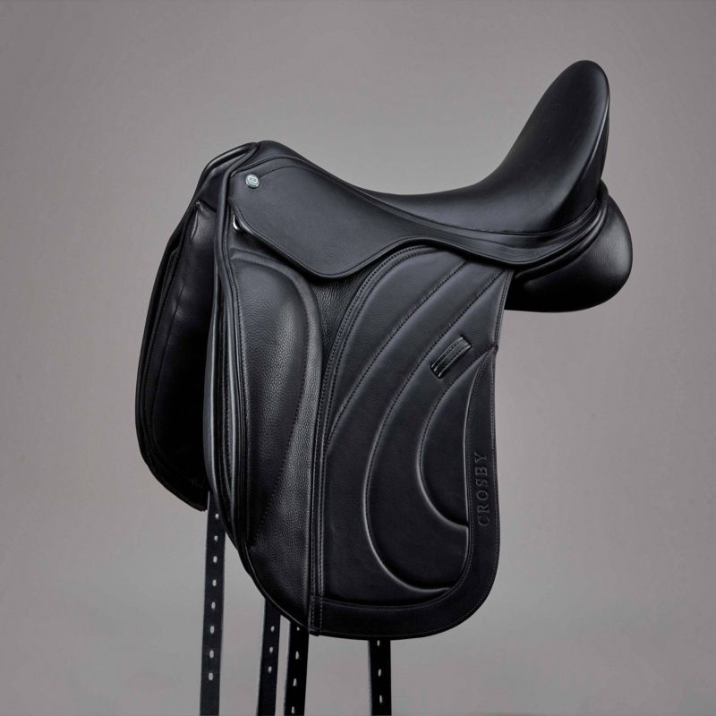 "Crosby black leather dressage saddle on a grey background."